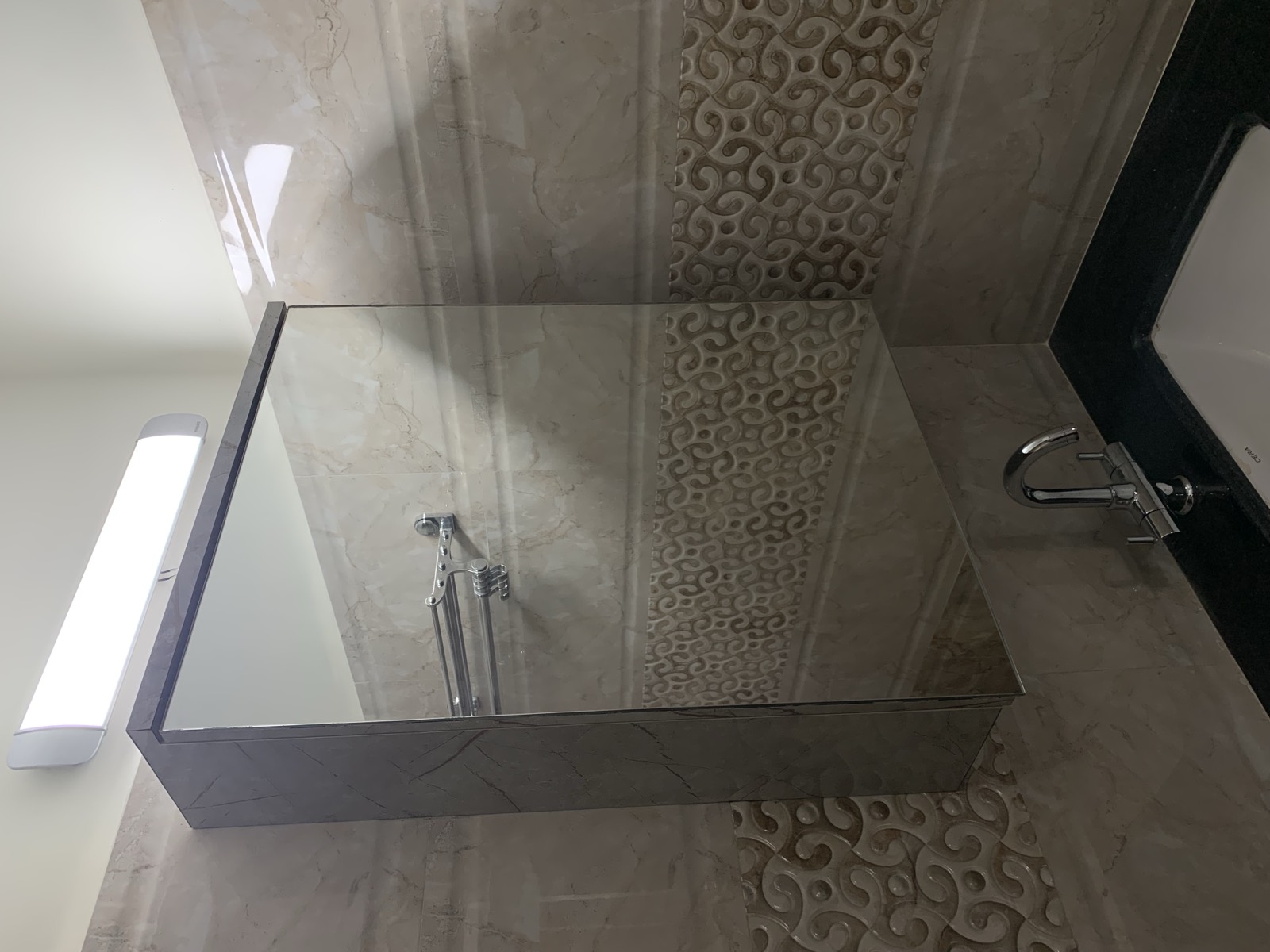 Renovated bathroom with marble-look tiling and vanity, Koramangala, Bangalore